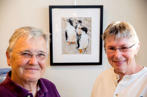 Fran Tomlinson (right) with her partner, Joy Pohl, in front of Fran’s pastel, “Tres Amigos.”